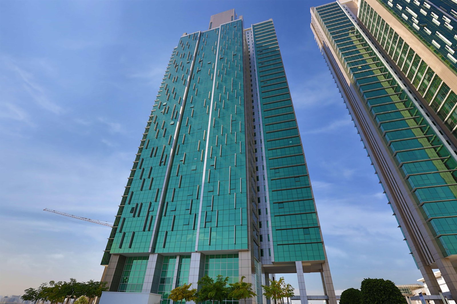 Al Durrah Tower Marina Square street-level exterior highlighting premium location near retail and marina walkways.